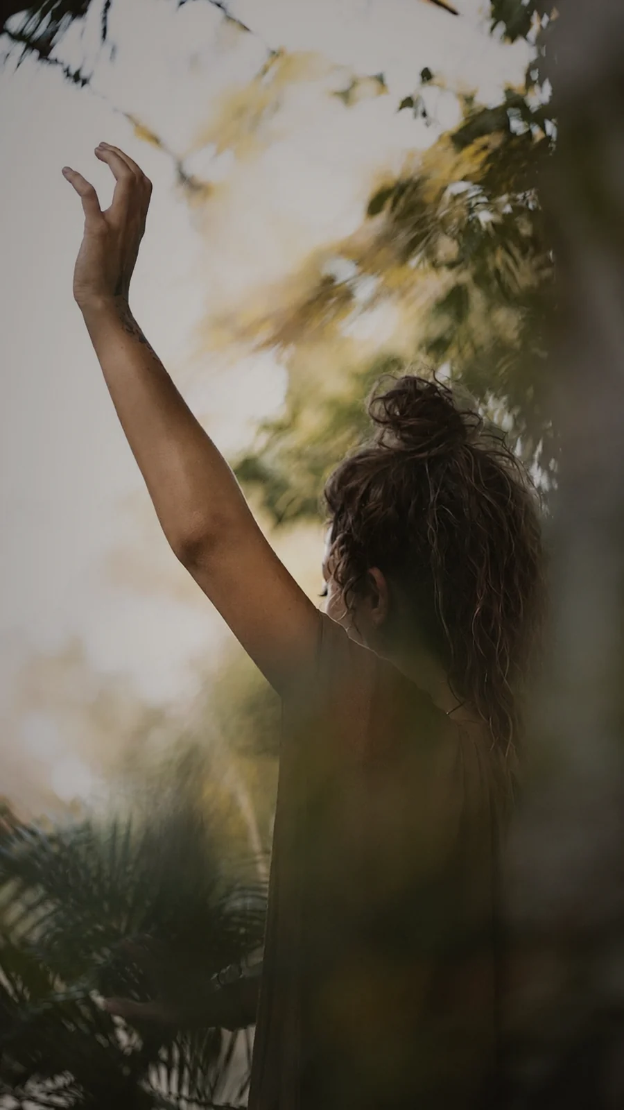 Andrea Sofía in a moment of presence, surrounded by nature and warm light